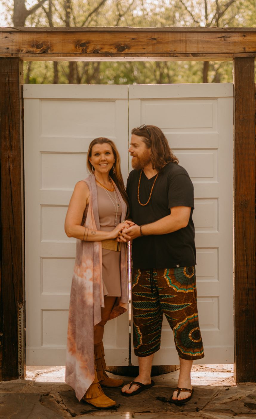 Destiny and Drew standing hand in hand before white wooden doors
